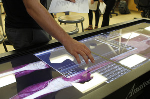 A student operates a device displaying a diagram of the human body.