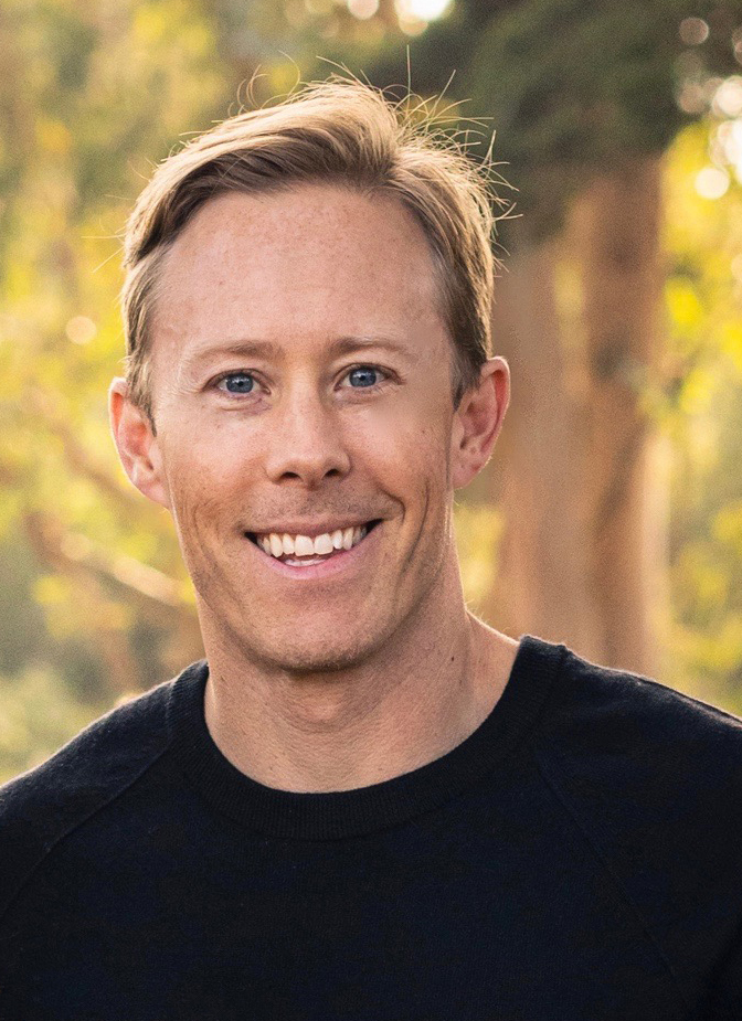 man in a black tshirt smiling