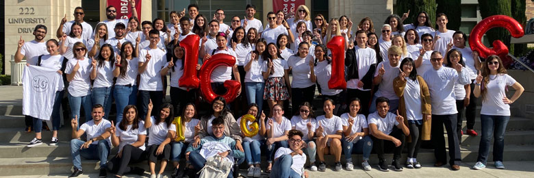 group of first-gen community members at Chapman University posing in a group holding "1G" balloons