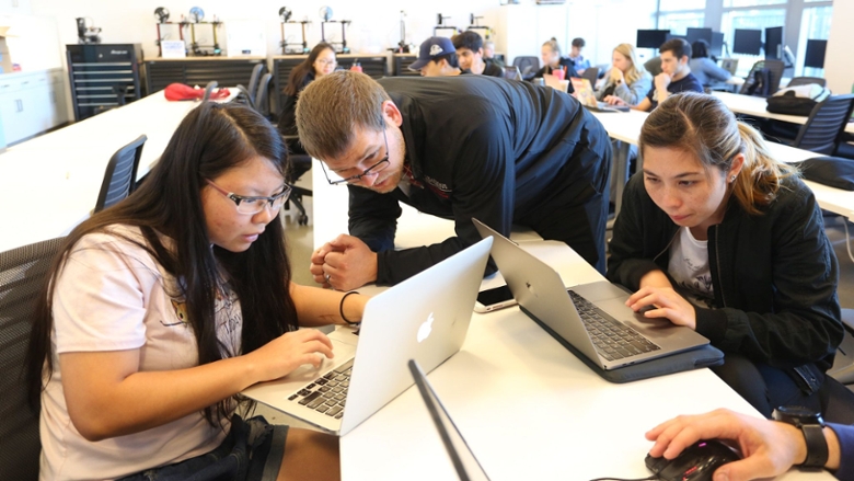 Chapman students working with their professor