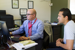 Student working with a staff member