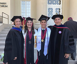 Italian Faculty and Graduates on front steps of Memorial Hall in cap and gown. 