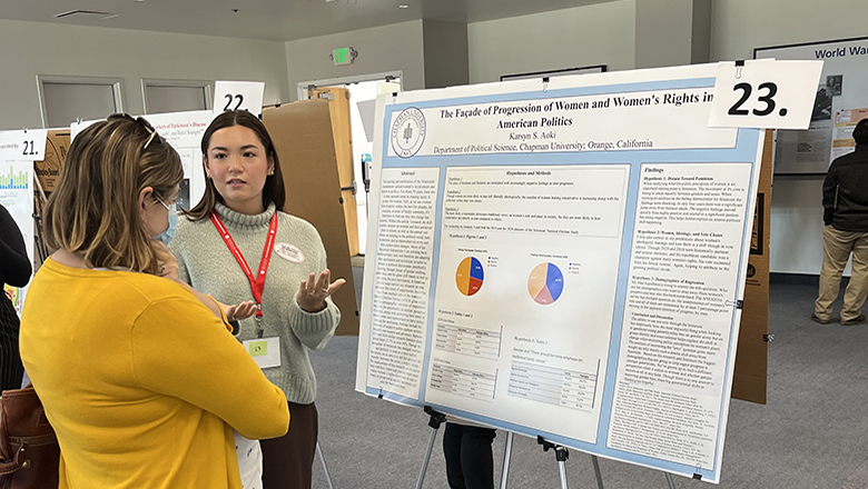 Political Science Student presenting research at symposium.