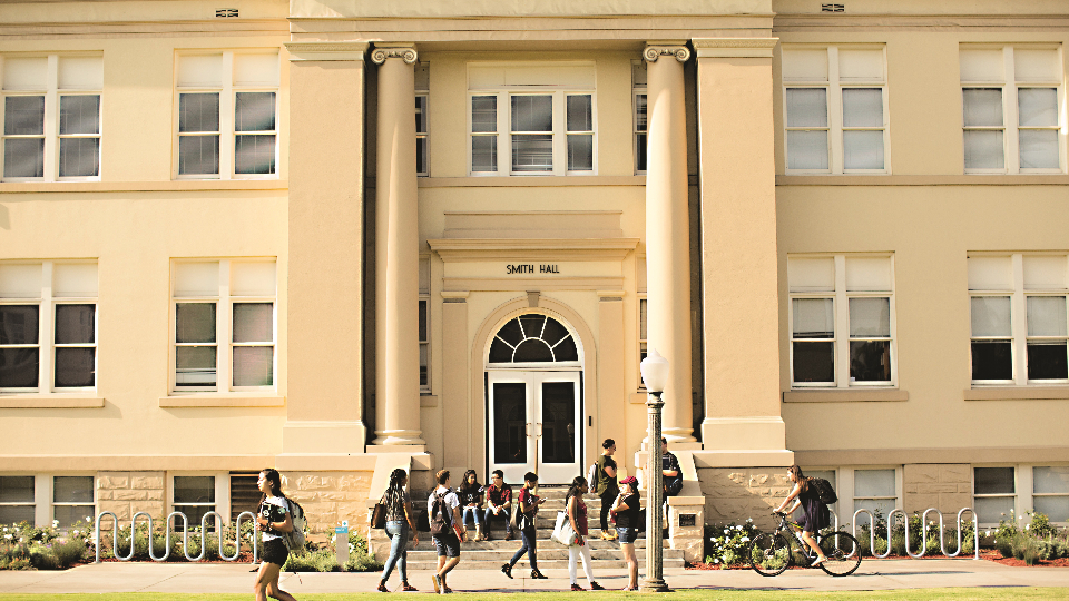 Students walking past building