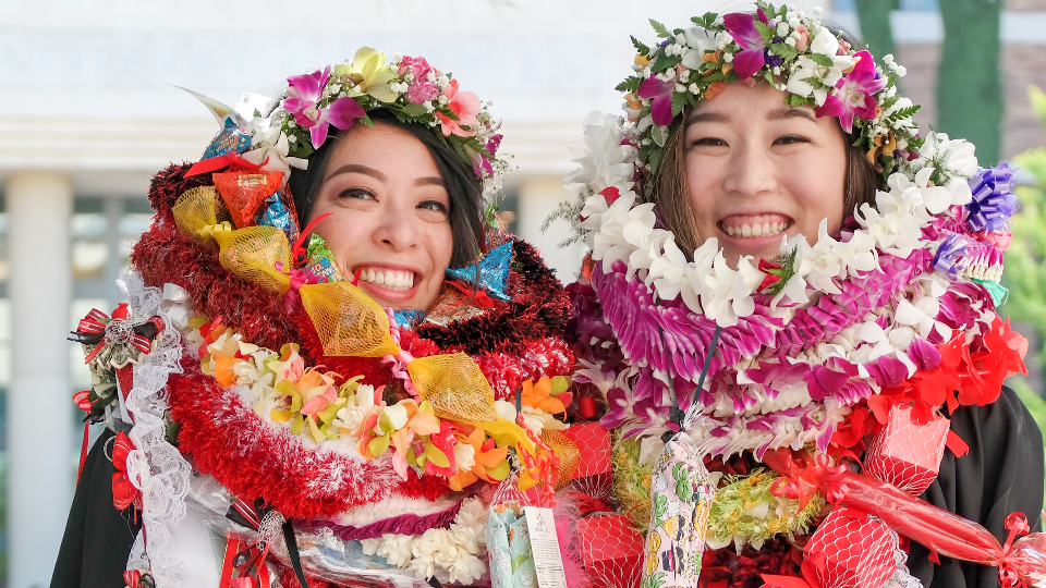 Smiling students covered in flowers