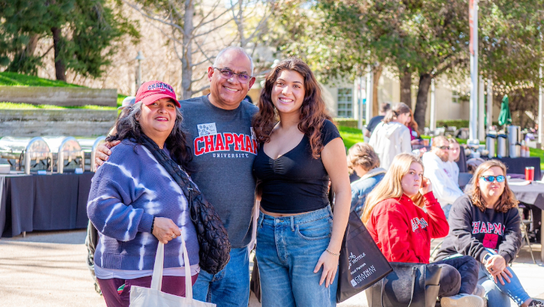 Chapman University student with their parents at event on campus