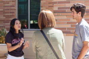 A Chapman student talking to campus guests