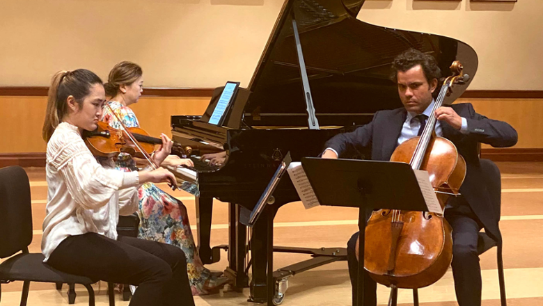 cellist, violinist, and pianist performing