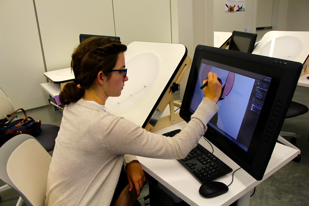 A student doing graphic design work on a computer