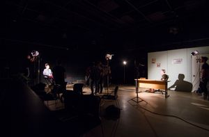 Students broadcasting in a dark studio