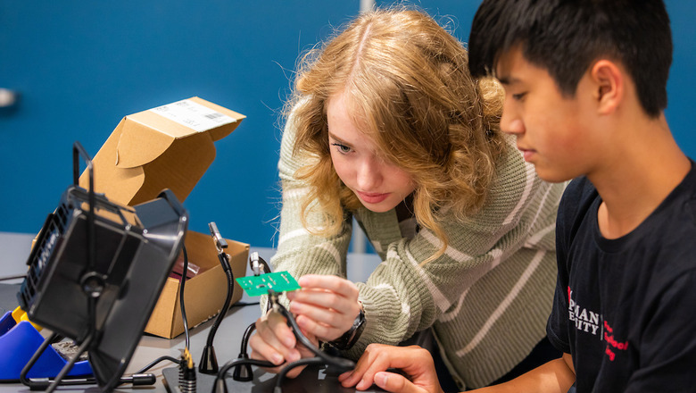 Two students working on an engineering project