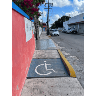 wheelchair symbol painted on sidewalk in Mexico