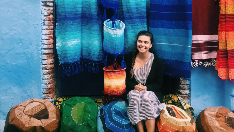 Colorful photo of tapestries and a student