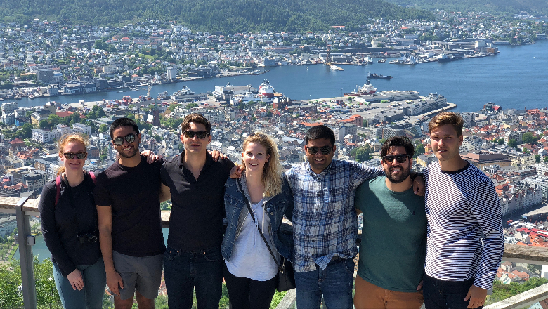 Male and female students overlooking scenic harbor in Europe