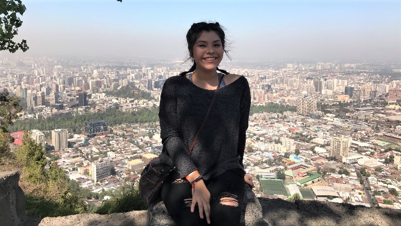 Student sitting on overlook to city in Argentina