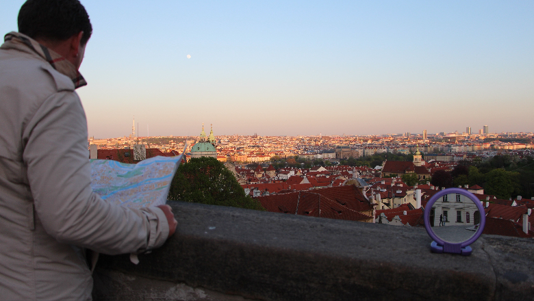 student looking over Prague city holding a map