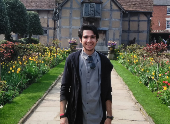 Student in front of village home in England