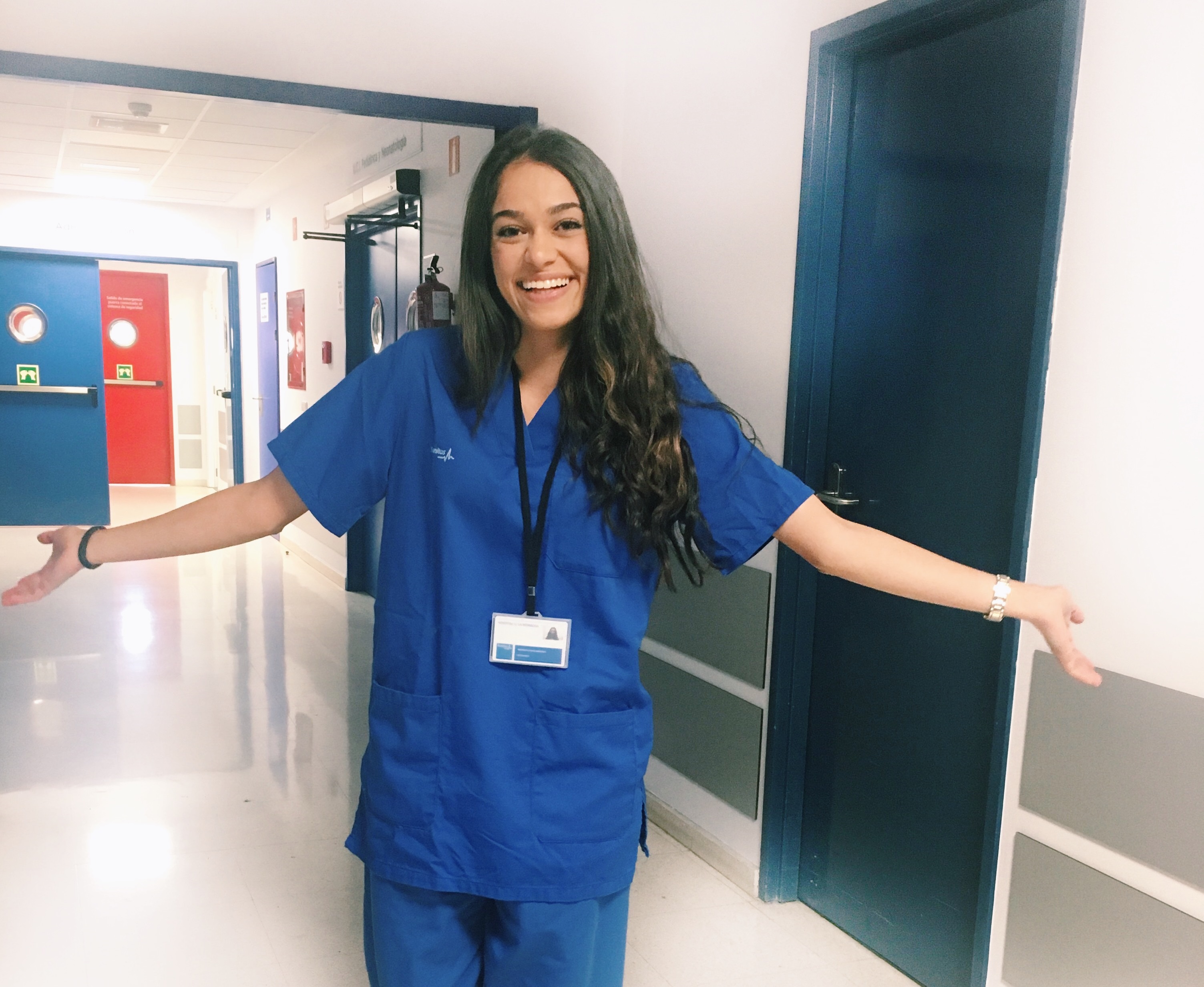 Female student in medical scrubs in a hospital building