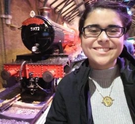 Student in front of train at Harry Potter museum